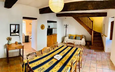 a living room with a table and a couch at Provencal farmhouse in Luberon's heart with pool in La Bastide-des-Jourdans