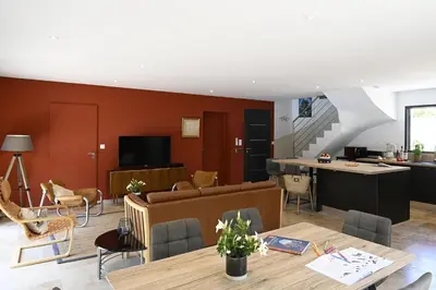a kitchen and living room with a table and chairs at La Villa Plein Soleil in LʼIsle-sur-la-Sorgue