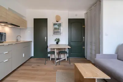 a kitchen and living room with a table and chairs at Studio climatisé plein centre ville 2ème ETAGE in Aix-en-Provence