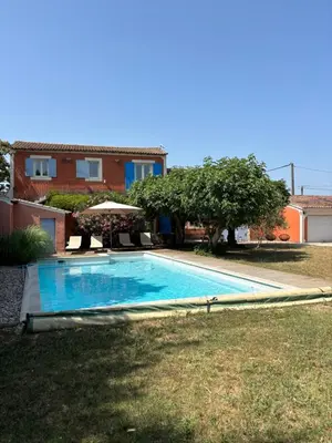 a swimming pool in the yard of a house at Mas de charme provencal in Cavaillon