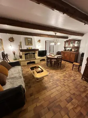 a living room with a couch and a table at Maison Provençale Vue Étang & Charme Médiéval in Saint-Chamas