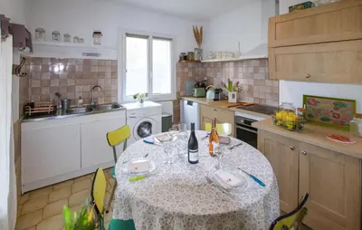 a kitchen with a table with a table cloth on it at Awesome Apartment In Carpentras in Carpentras