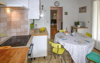 a kitchen with a table with yellow chairs in it at Awesome Apartment In Carpentras in Carpentras