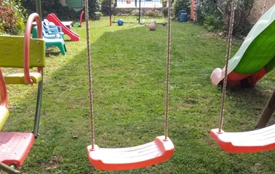 a group of swings in a yard at Awesome Apartment In Carpentras in Carpentras