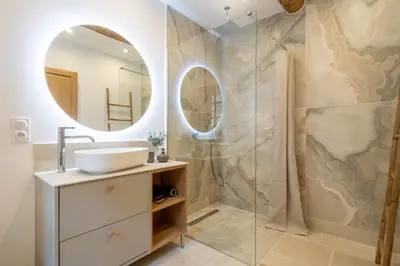 a bathroom with a sink and a mirror at Exceptionnel - Couvent entièrement rénové - classé Patrimoine - Piscine, au calme et à 100 m du coeur de l'Isle in LʼIsle-sur-la-Sorgue