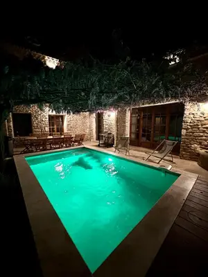 a swimming pool lit up at night at Exceptionnel - Couvent entièrement rénové - classé Patrimoine - Piscine, au calme et à 100 m du coeur de l'Isle in LʼIsle-sur-la-Sorgue