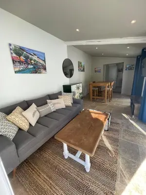 a living room with a couch and a table at La l isloise in LʼIsle-sur-la-Sorgue