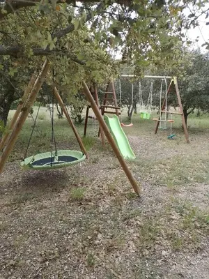 an empty swing set in a park at Lou mazet in La Roque-sur-Pernes