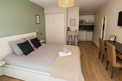 a bedroom with a bed and a dining room at 119 Sous le ciel de Provence - Aix in Éguilles