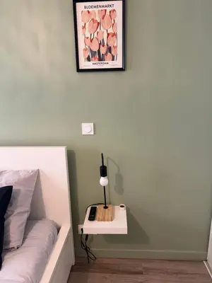 a bedroom with a bed with a nightstand and a lamp at 119 Sous le ciel de Provence - Aix in Éguilles