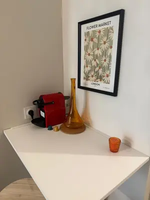 a white shelf with a picture and a vase on it at 119 Sous le ciel de Provence - Aix in Éguilles