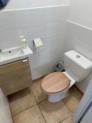 a bathroom with a toilet and a sink at Chez DOMI in LʼIsle-sur-la-Sorgue