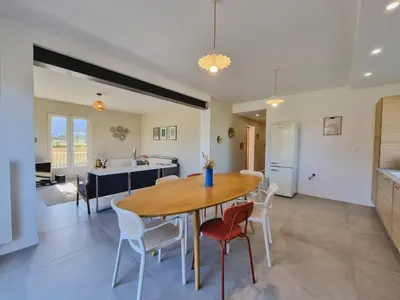 a kitchen and dining room with a table and chairs at Lou Miradou in Maubec