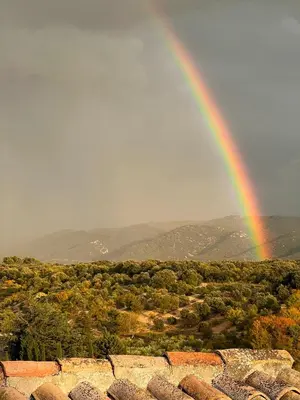 a rainbow in the sky over a field at Le Mas de Quatremonts - Your refuge in Provence in Bonnieux