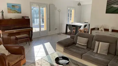 a living room with a couch and a piano at Maison provençale familiale avec piscine - 6 personnes in Lambesc