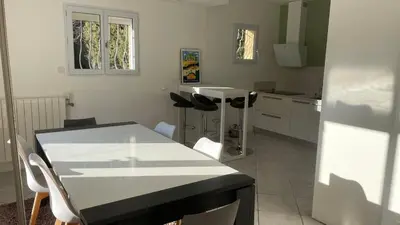 a kitchen with a black and white table and chairs at Maison provençale familiale avec piscine - 6 personnes in Lambesc