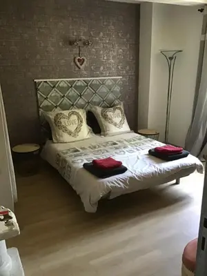 a bedroom with a bed with red towels on it at Gites victoria in Cavaillon