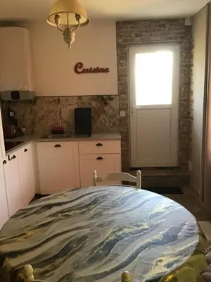 a kitchen with a bed and a window and a door at Gites victoria in Cavaillon