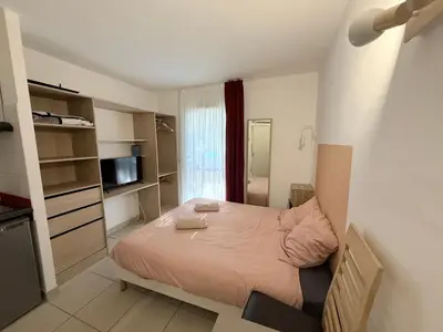 a small bedroom with a bed and a television at Le Clos d'Aix Célony studio 9 parking in Aix-en-Provence