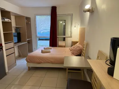 a small bedroom with a bed and a window at Le Clos d'Aix Célony studio 9 parking in Aix-en-Provence