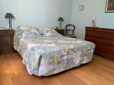 a bedroom with a bed with a floral comforter at Villa avec piscine dans le Luberon in La Tour-dʼAigues