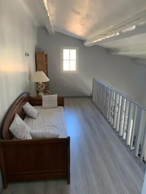 a bedroom with a bed and a window and a staircase at Villa avec piscine dans le Luberon in La Tour-dʼAigues