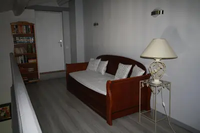 a small bedroom with a bed and a lamp at Villa avec piscine dans le Luberon in La Tour-dʼAigues