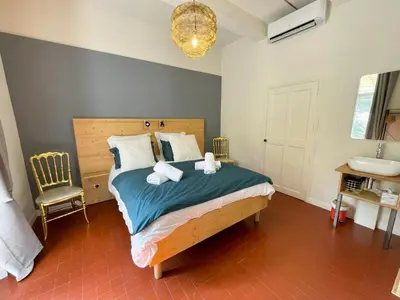 a bedroom with a bed with two towels on it at House By The Sorgue River With Private Access in Fontaine-de-Vaucluse