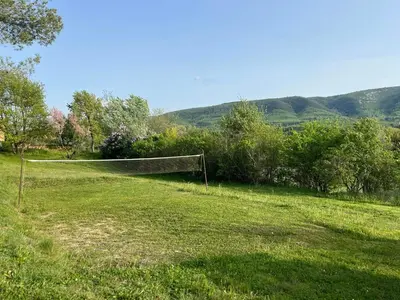 a garden with a wooden table and a gazebo at Historic Bastide With Private Pool In The Luberon in Céreste