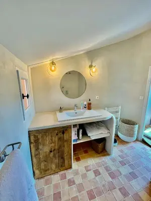 a bathroom with a sink and a mirror at Bohemian House Overlooking Roussillon in Roussillon