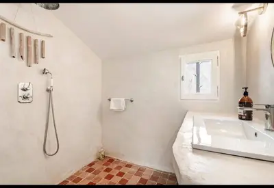 a white bathroom with a sink and a shower at Bohemian House Overlooking Roussillon in Roussillon