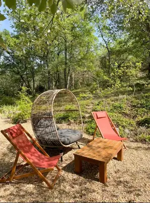 a couple of chairs and a table and a swing at Peaceful Retreat In The Heart Of Luberon in Roussillon