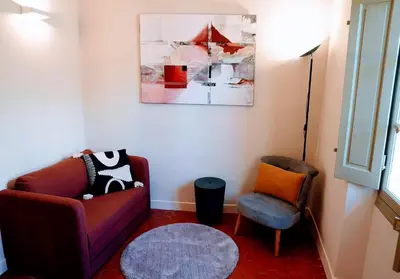 a living room with a couch and a chair at Les Terrasses de Ventabren in Ventabren