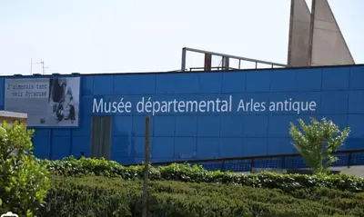 a building with a sign on the side of it at Appartement de charme au pied du château in Châteaurenard