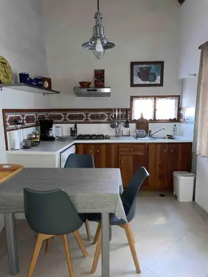a kitchen with a table and some chairs and a table and a table at Appartement de charme au pied du château in Châteaurenard