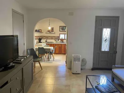a living room with a dining room and a kitchen at Appartement de charme au pied du château in Châteaurenard