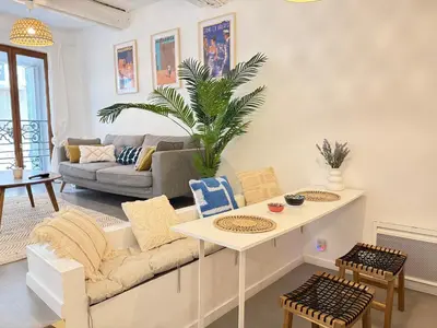 a living room with a couch and a table at Chic et Cosy, Hyper centre in Aix-en-Provence