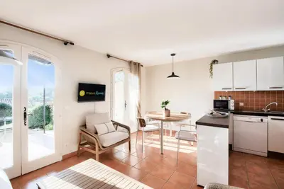 a kitchen and living room with a table and chairs at Village Pont Royal en Provence - maeva Home - Maison climatisée 4 pièces 6 personnes - Sélection - super Home MAE-0411 in Mallemort