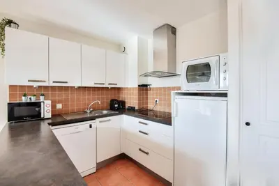 a kitchen with white cabinets and a microwave at Village Pont Royal en Provence - maeva Home - Maison climatisée 4 pièces 6 personnes - Sélection - super Home MAE-0411 in Mallemort