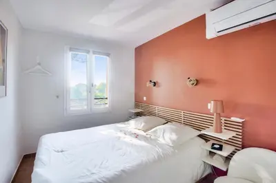 a bedroom with a white bed and a window at Village Pont Royal en Provence - maeva Home - Maison climatisée 4 pièces 6 personnes - Sélection - super Home MAE-0411 in Mallemort