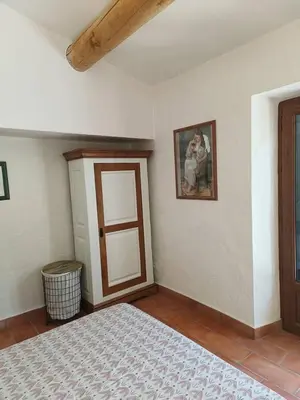 a room with a bed and a painting on the wall at Air-conditioned Stylish Provence Villa in Oppède