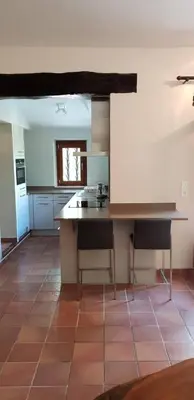 a kitchen with a table and chairs in a room at Air-conditioned Stylish Provence Villa in Oppède