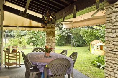 a table and chairs under a pergola at MAISON de CHARME in Cavaillon