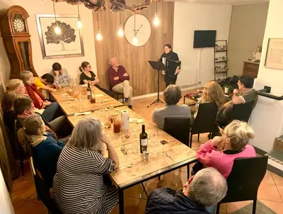 a group of people sitting around a table in a room at La Roselière in Mérindol