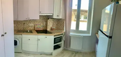 a kitchen with white cabinets and a sink and a window at Appartement cosy lumineux et calme in Apt
