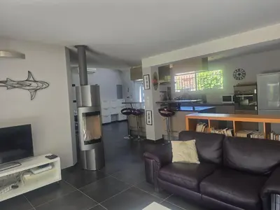 a living room with a couch and a television at Maison Climatisée, Jardin, Piscine, 7 pers in Salon-de-Provence