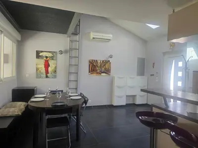 a dining room with a table and some chairs at Maison Climatisée, Jardin, Piscine, 7 pers in Salon-de-Provence