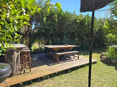 a wooden deck with a picnic table and a stool at Maison Climatisée, Jardin, Piscine, 7 pers in Salon-de-Provence