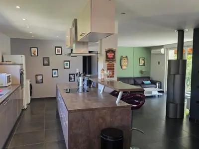 a kitchen with a island in the middle of a room at Maison Climatisée, Jardin, Piscine, 7 pers in Salon-de-Provence