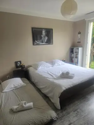 a bedroom with two beds with towels on them at Maison Climatisée, Jardin, Piscine, 7 pers in Salon-de-Provence